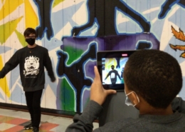 Year 3 James Lyng High School Oracle Productions Image of Students in front of a mural shooting a video