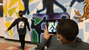 Year 3 James Lyng High School Oracle Productions Image of Students in front of a mural shooting a video