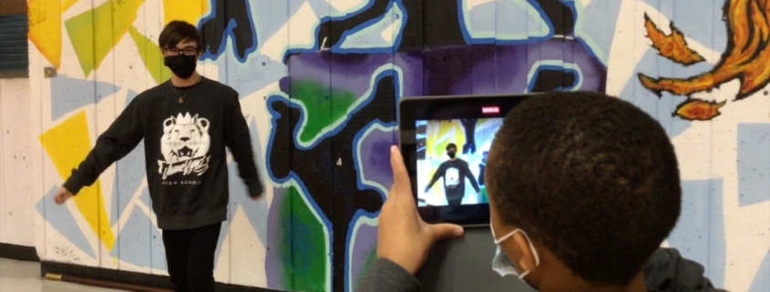 Year 3 James Lyng High School Oracle Productions Image of Students in front of a mural shooting a video