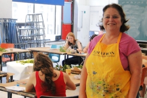 Art Educator in a classroom with 3 students