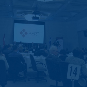 large conference room with PERT projected on a screen