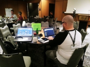 man on a computer at conference