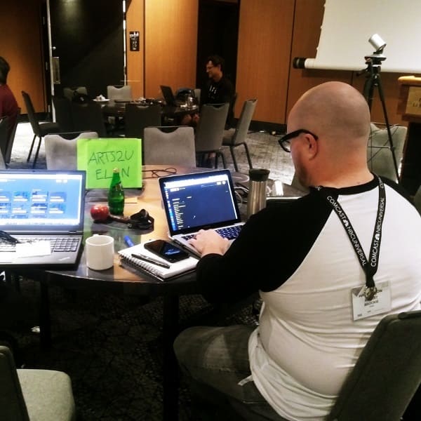 man using laptop at a conference